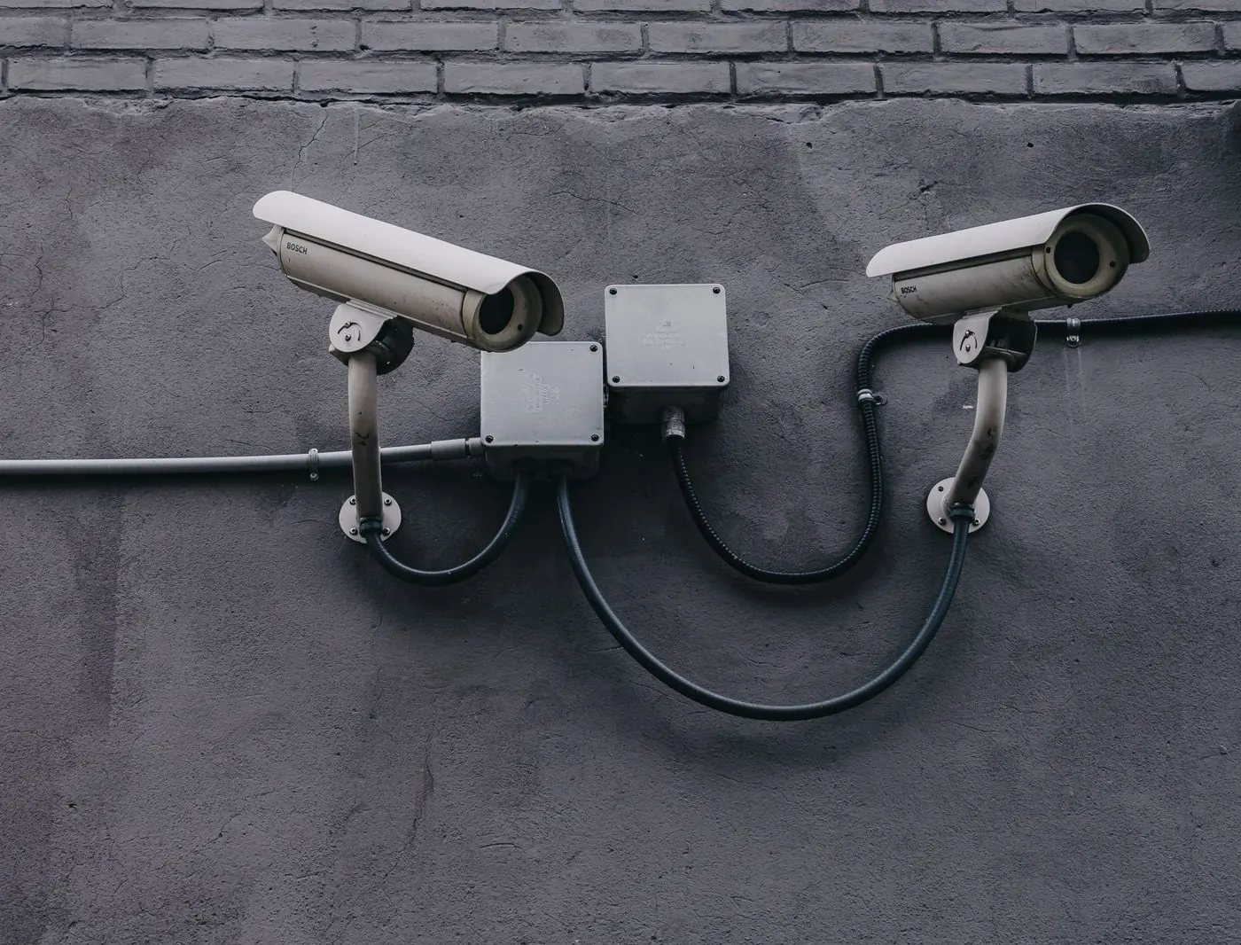 Two security cameras mounted on a wall