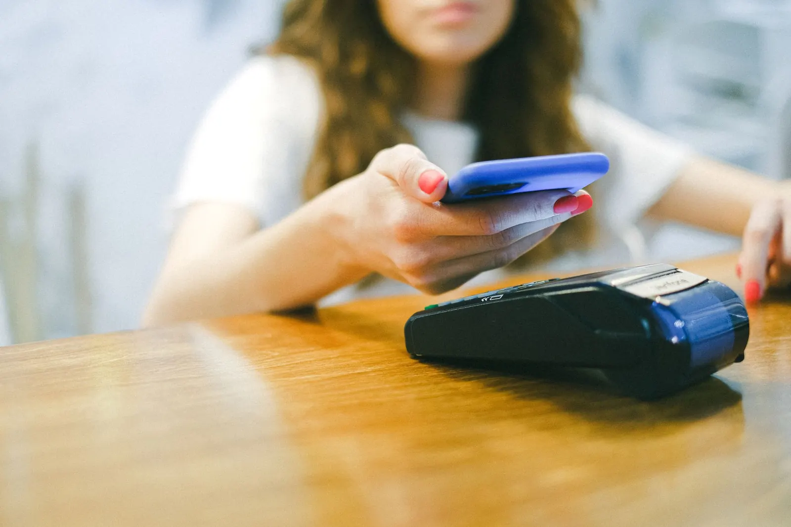 Customer paying with a phone on a card reader